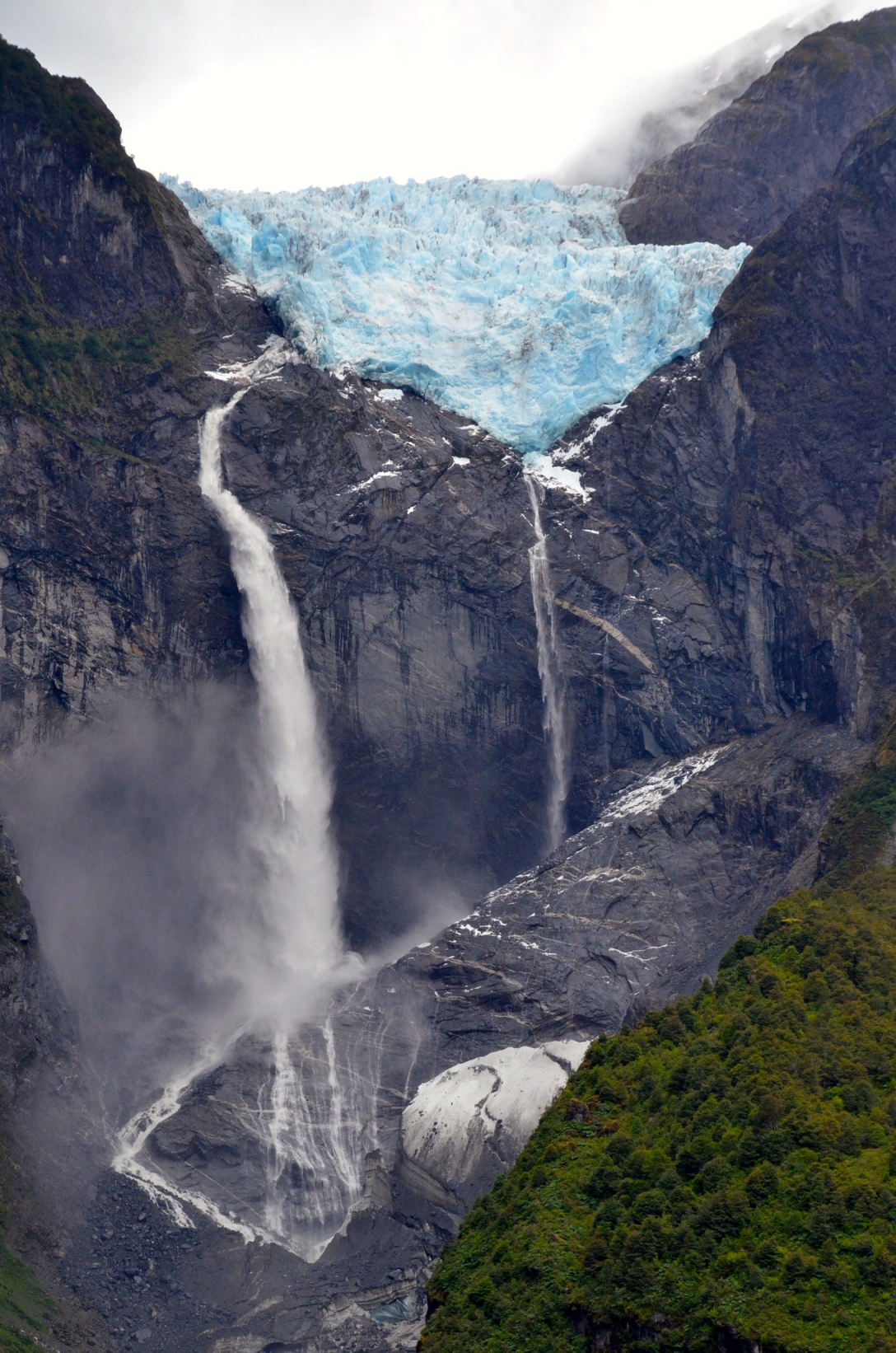 Waterfalls spill from a hanging glacier in Queulat national Park, Chile 